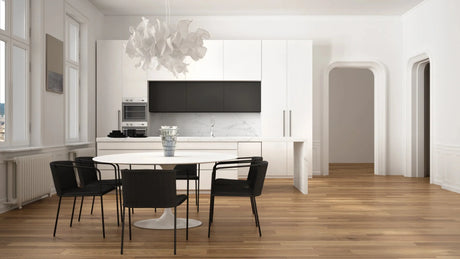 Sleek modern kitchen with white cabinets and warm-toned vinyl plank flooring.
